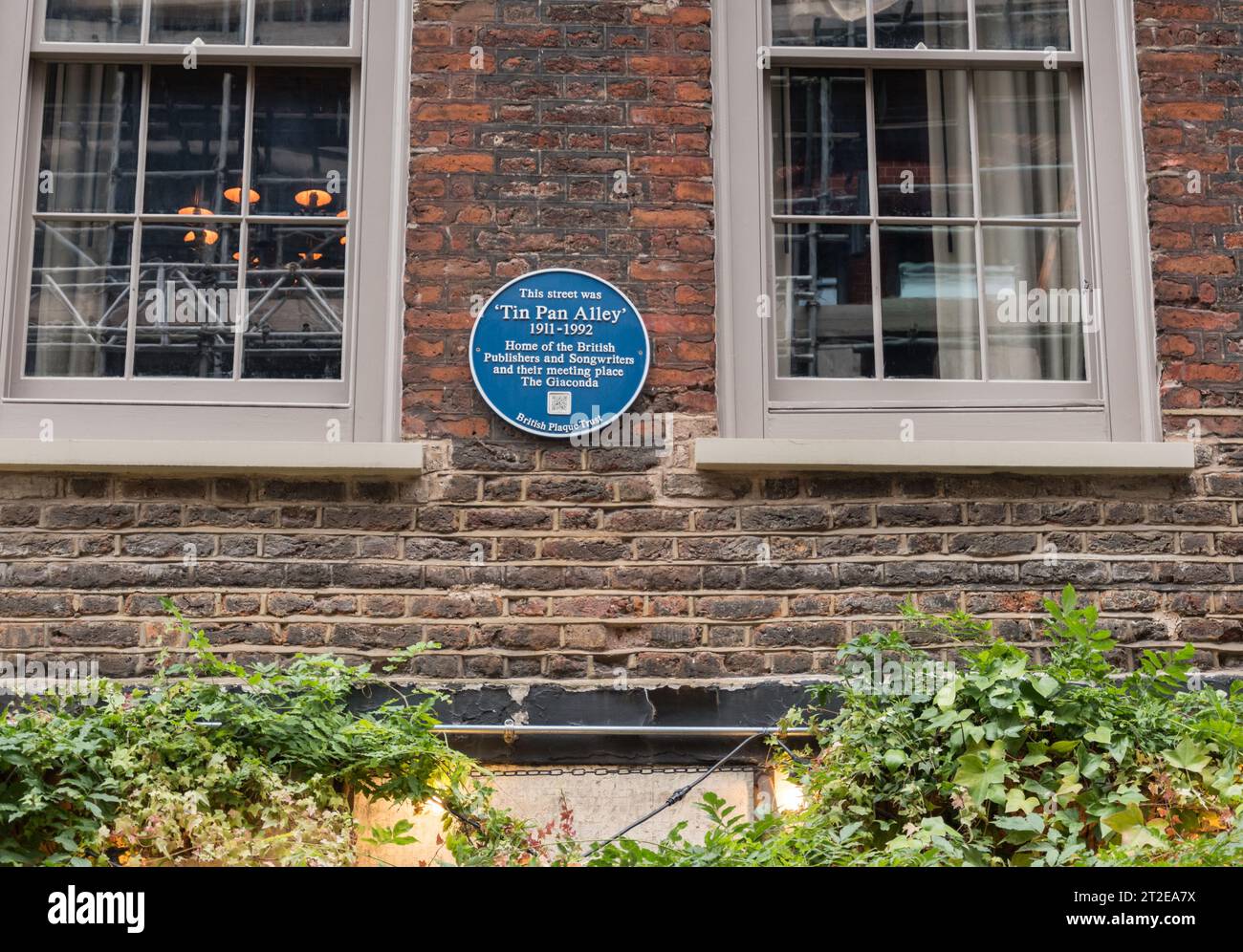 Blue Plaque on a brick wall commemorating the location of Tin Pan Alley
