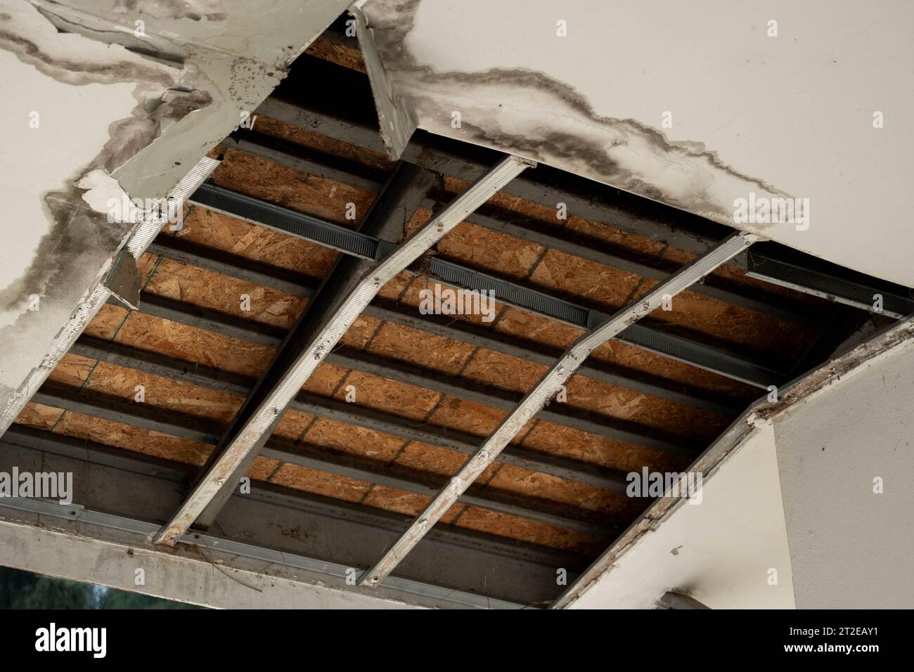 Ceiling panels had damaged a large hole in the roof from a rainwater leak. Ceiling damaged by