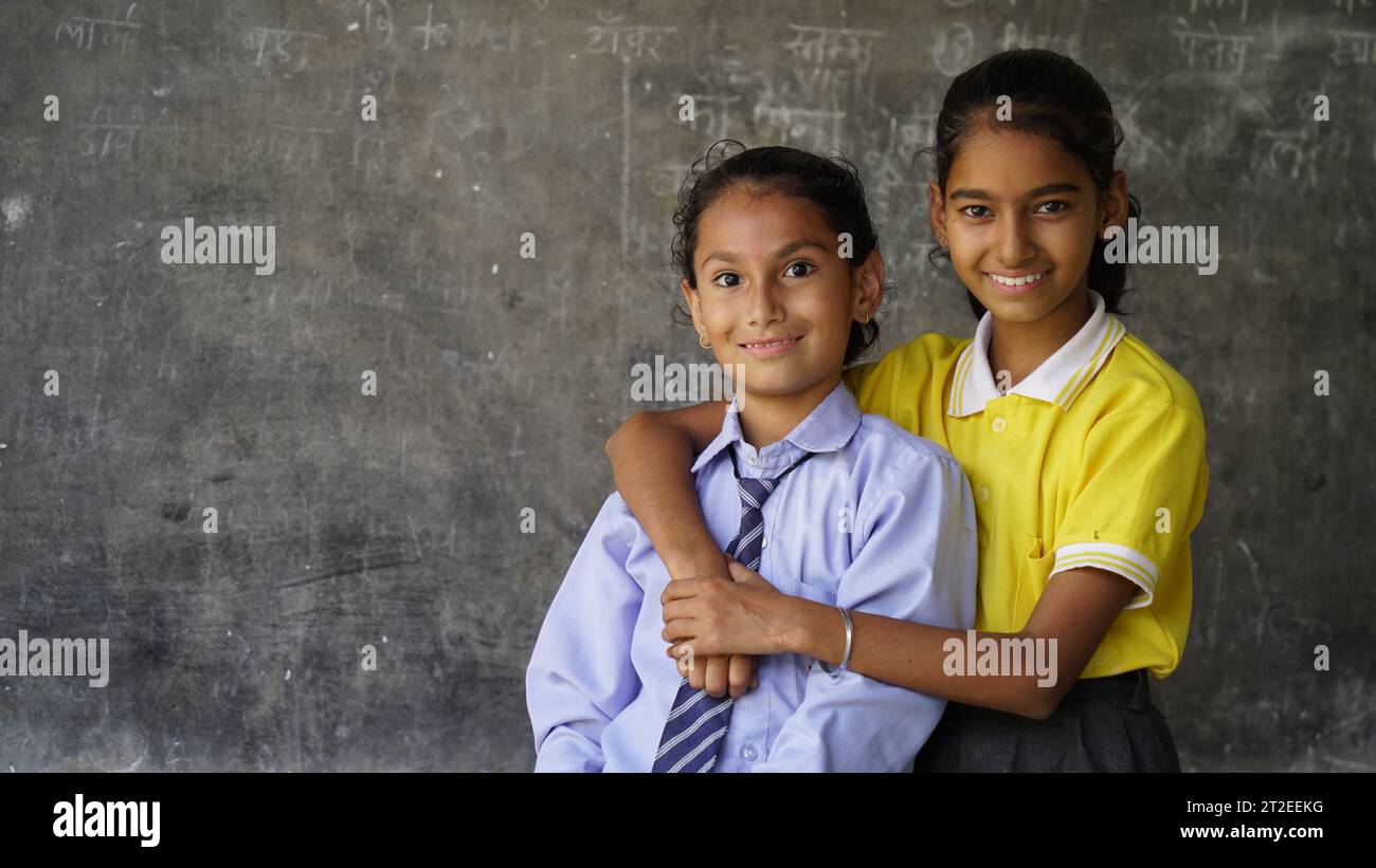 Portrait of happy indian school child sitting at desk in classroom, school kids with pens and notebooks writing test Elementary school, Education conc Stock Photo