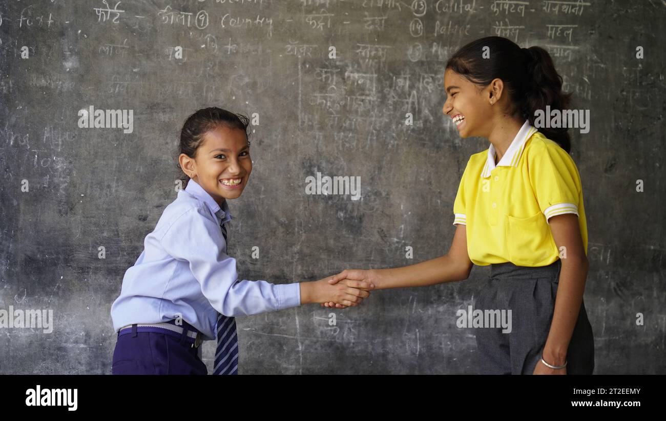 Portrait of Happy Indian school kids wearing school uniform. Skill India concept. Education concept. Rural India. Concept of friendship, education and Stock Photo