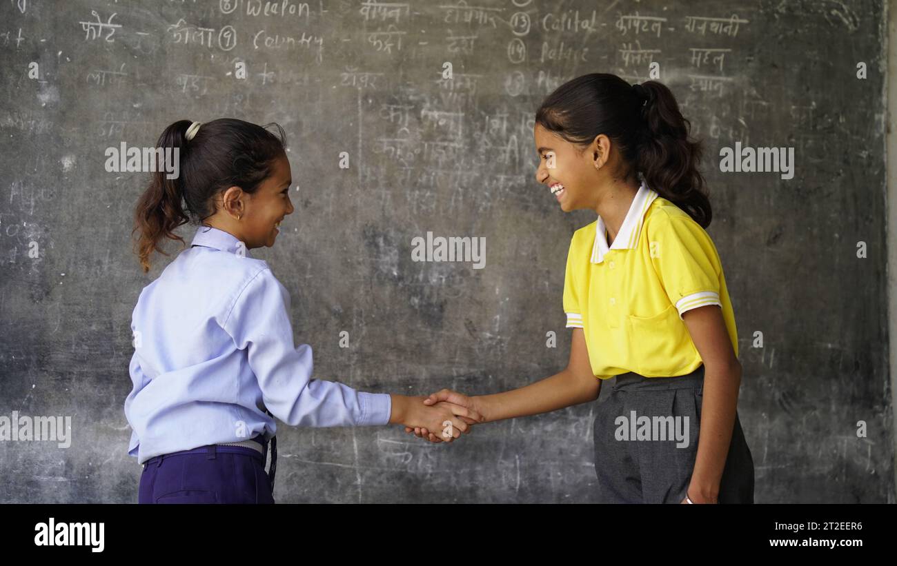 Portrait of Happy Indian school kids wearing school uniform. Skill India concept. Education concept. Rural India. Concept of friendship, education and Stock Photo