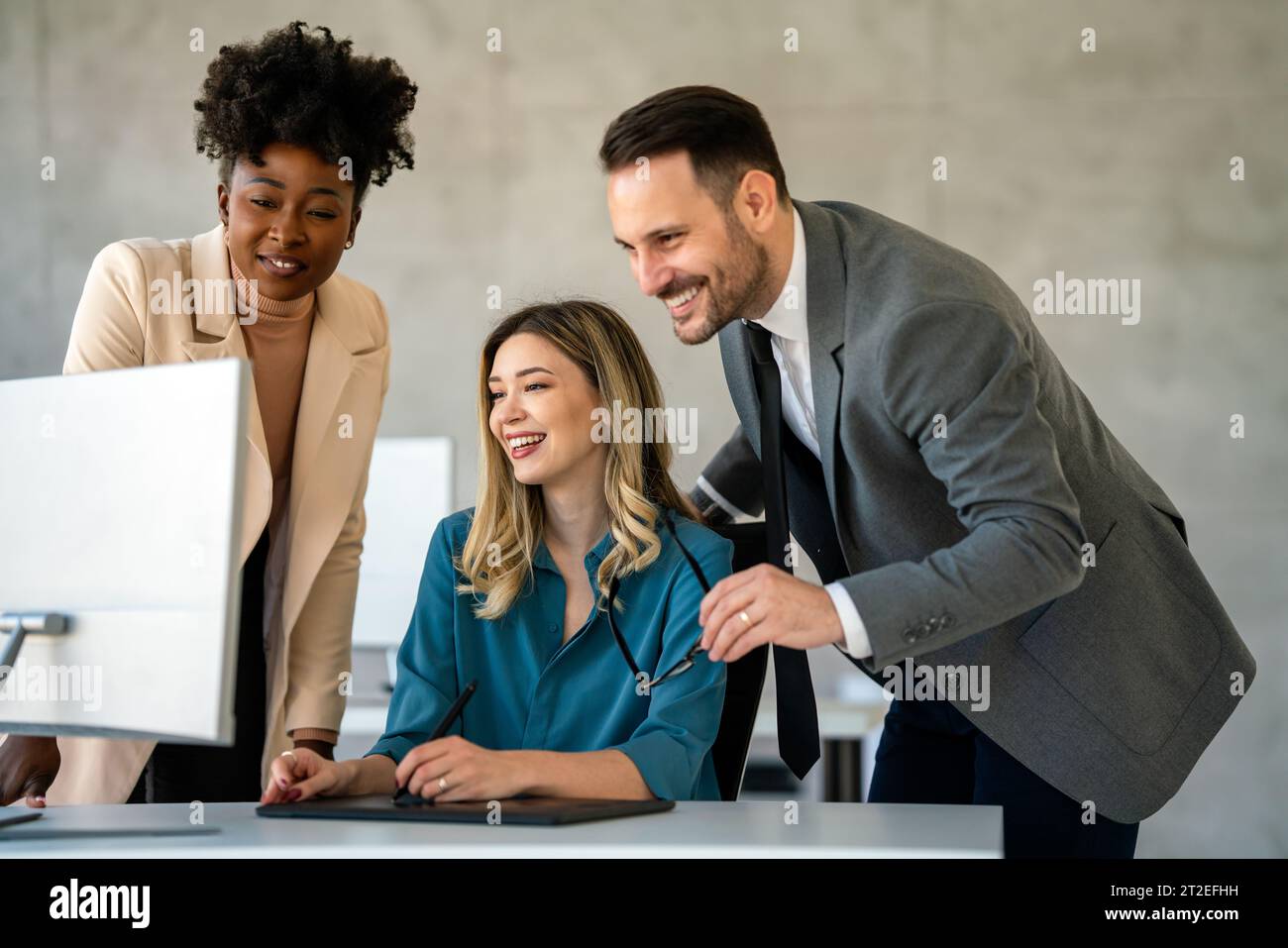 Group of multiethnic business people analyzing data using computer while working in the office Stock Photo
