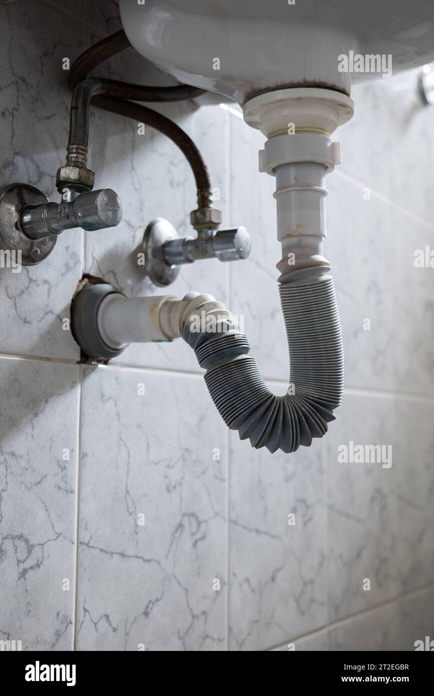 Bathroom sink drainage plastic flexible hose. Underneath view, natural