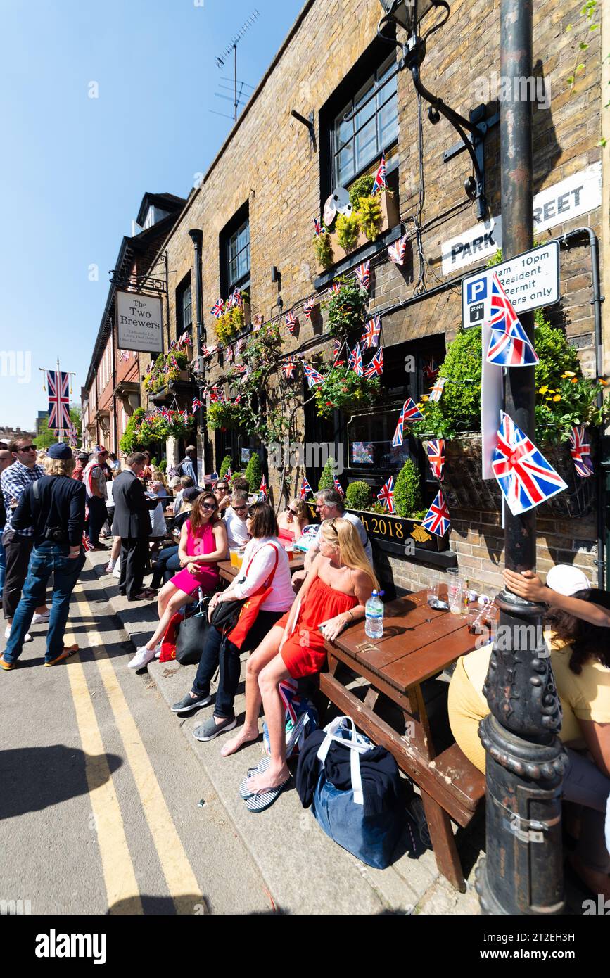 People relaxing outside the The Two Brewers pub, Park Street, Windsor, Berkshire, UK, after lining the streets for the Royal Wedding of Harry & Meghan Stock Photo