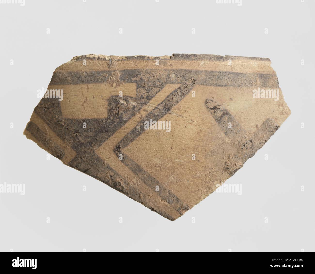 Sherd Iran ca. 2700–2500 BCE This sherd is made of a buff clay, with brown painted decoration. It is typical of Namazga IV ceramics from Turkmenistan, dating to ca. 2700-2500 B.C. It was excavated in 1937 at a prehistoric site in the vicinity of Nishapur in northeastern Iran. While Nishapur itself was founded by the Sasanian king Shapur I (reigned ca. A.D. 241-272), this sherd shows that human habitation there goes back to the prehistoric period. Furthermore, the prehistoric pottery from Nishapur has close affinities with ceramic materials from Central Asia rather than with contemporary sites Stock Photo