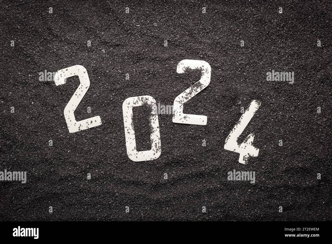 Happy New Year 2024 New Year 2024 concept on the black sand of a beach