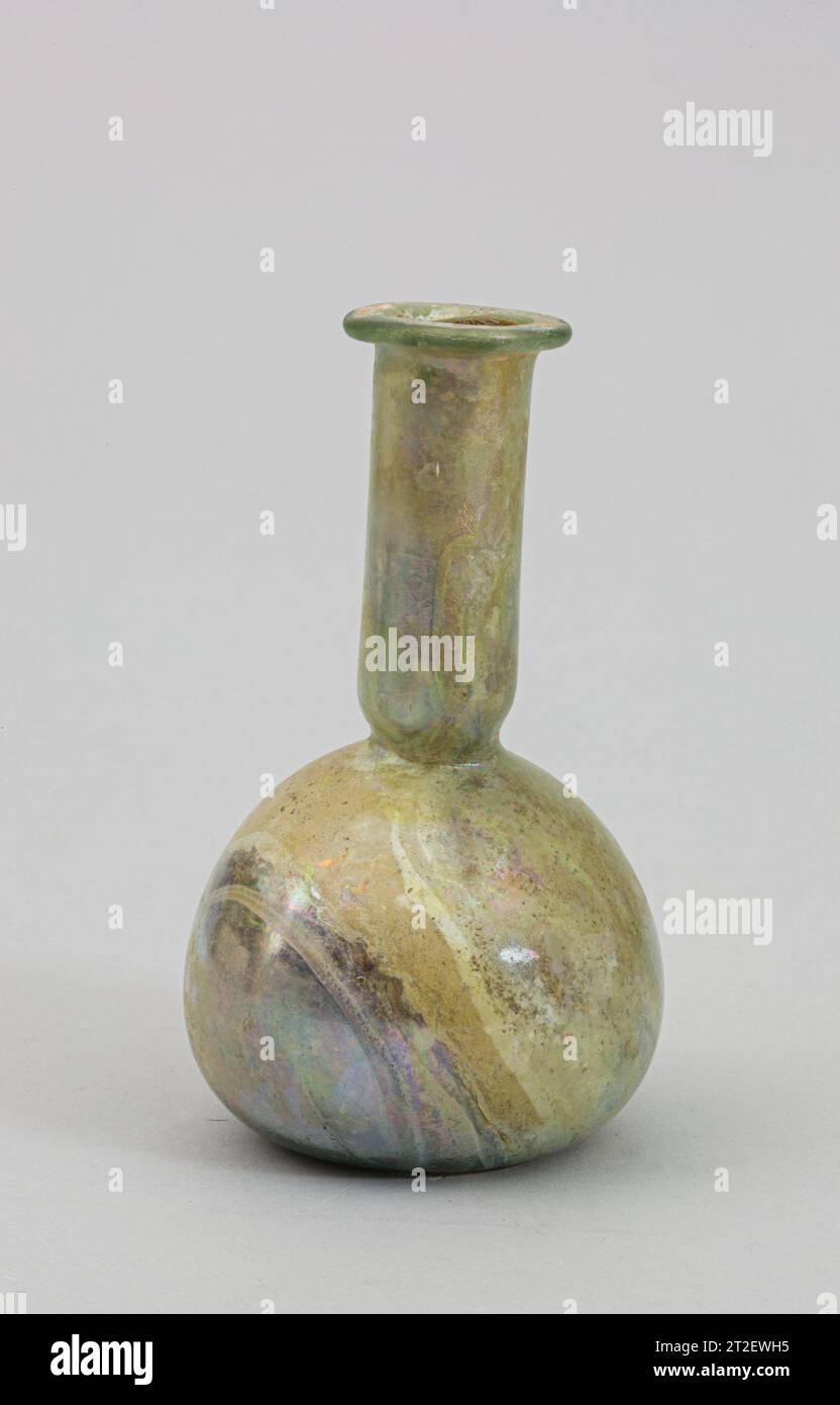Glass perfume bottle Roman late 1st–3rd century CE Translucent pale blue green.Everted rim, folded over and in, and pressed flat around mouth; cylindrical neck, with deep horizontal tooled indent around base; bulbous body; almost flat bottom.Intact; some bubbles; slight pitting and faint iridescence on exterior, soil encrustation, weathering, and brilliant iridescence on interior. View more. Glass perfume bottle. Roman. late 1st–3rd century CE. Glass; blown. Imperial. Glass Stock Photo