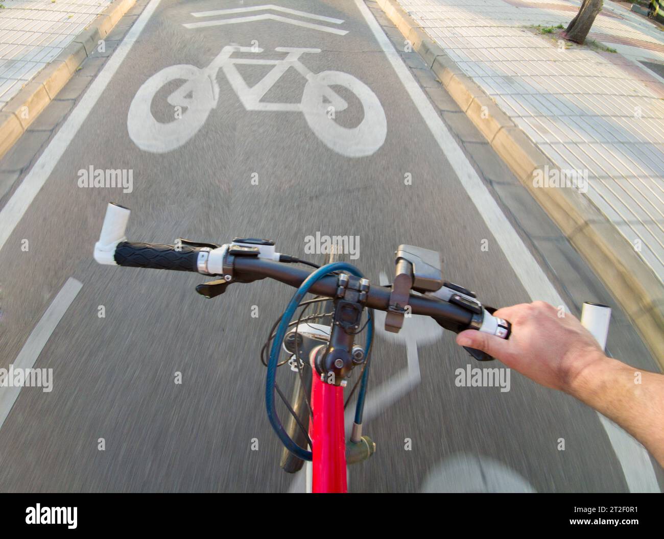 Cyclist riding y priority lane for bikes and electric kick scooters