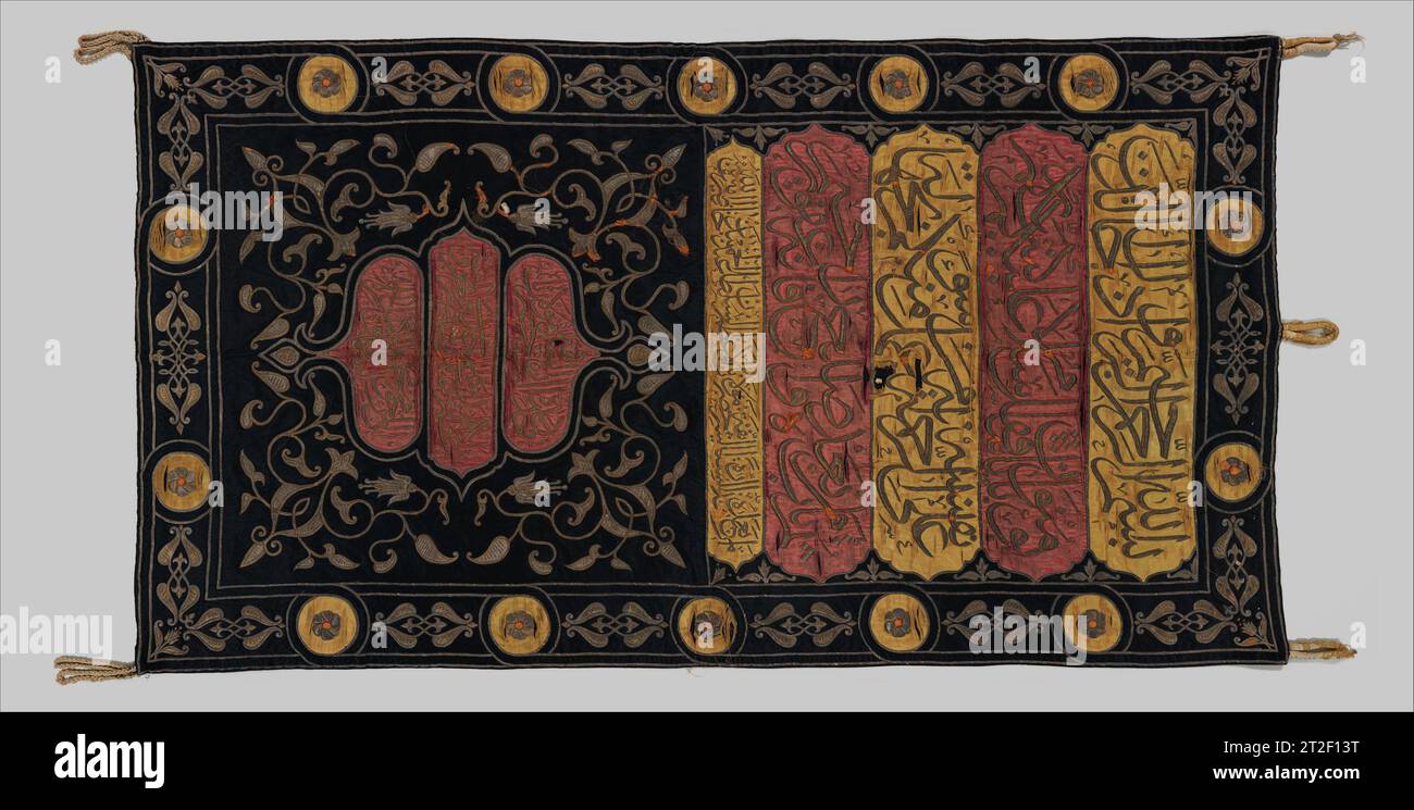 Sitara, Interior Door Curtain of the Ka'ba Patron Sultan Abdülhamid II Ottoman Turkish Workshop of Warshat al-Khurunfish Egyptian dated 1315 AH/1897–98 CE This Sitara is a very rare example of a curtain that once hung inside the Bab al-Tawba (Door of Repentance) of the Ka‘ba, the structure in Mecca that Muslims believe is the house of God on earth. The Ottoman sultan’s name, Abdülhamid II, who had the imperial prerogative of ordering the replacement of textiles for the Ka‘ba, appears in the fifth line beneath four qur’anic cartouches. A medallion-like calligraphic composition in the center of Stock Photo