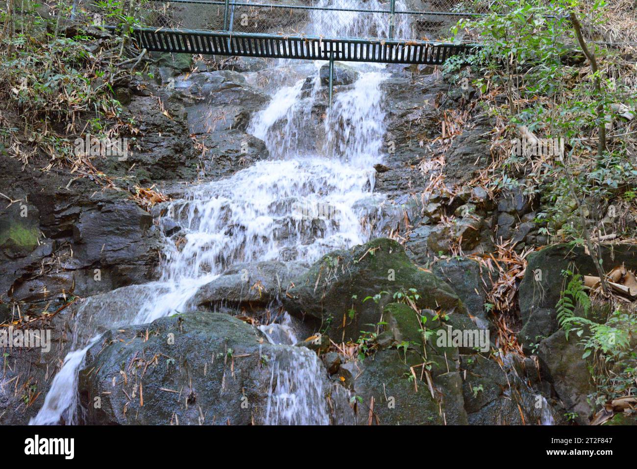 Waterfall with gazebo built in iron and painted in green. Wide angle Stock Photo