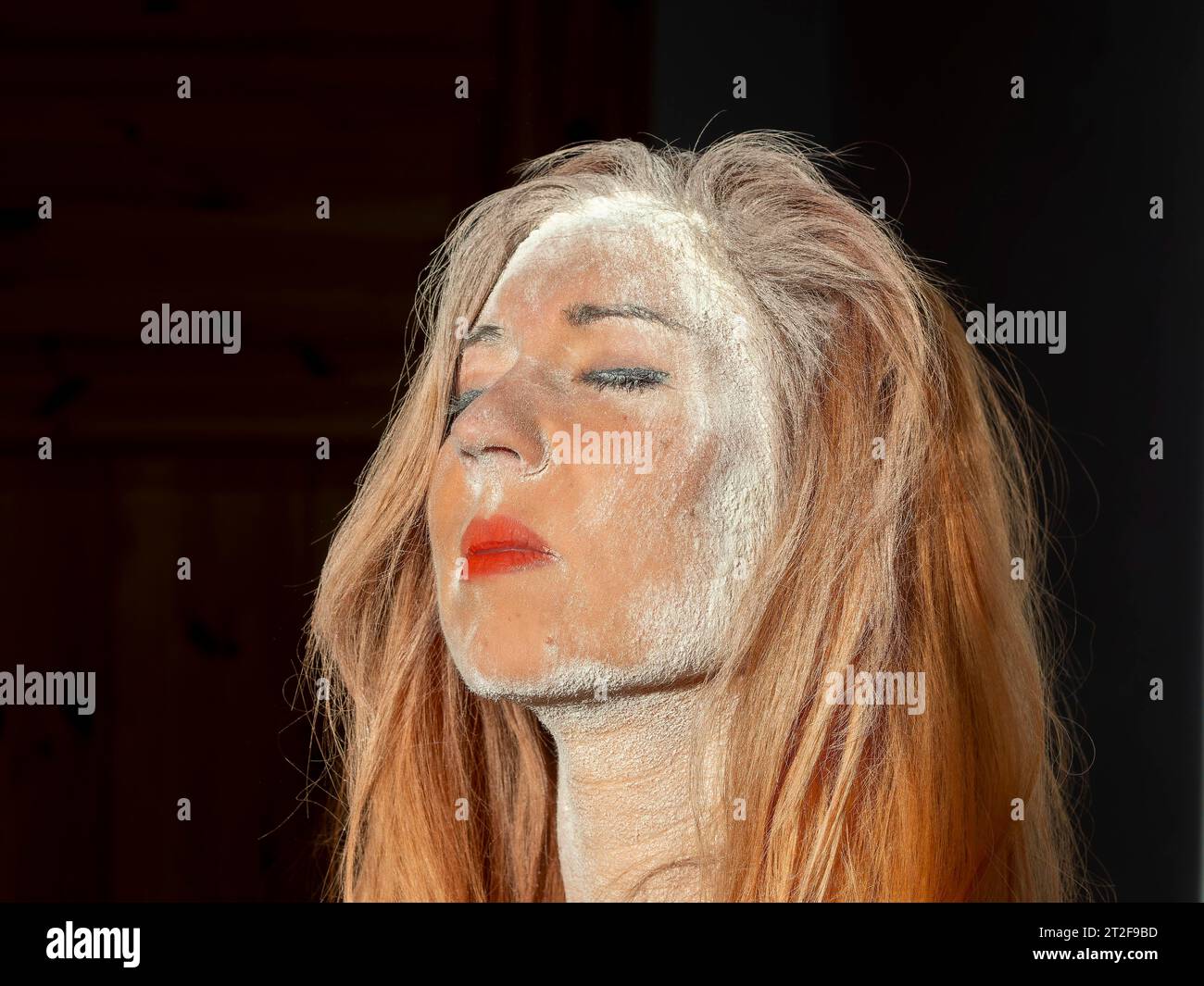 Woman with red lips, long hair, dusty face, drama, despair, suffering and war Stock Photo