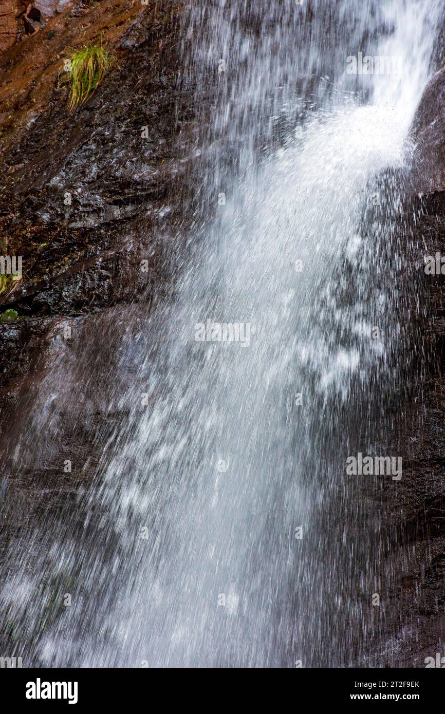 Water splashing in the collision between the waterfall and the rocks in ...
