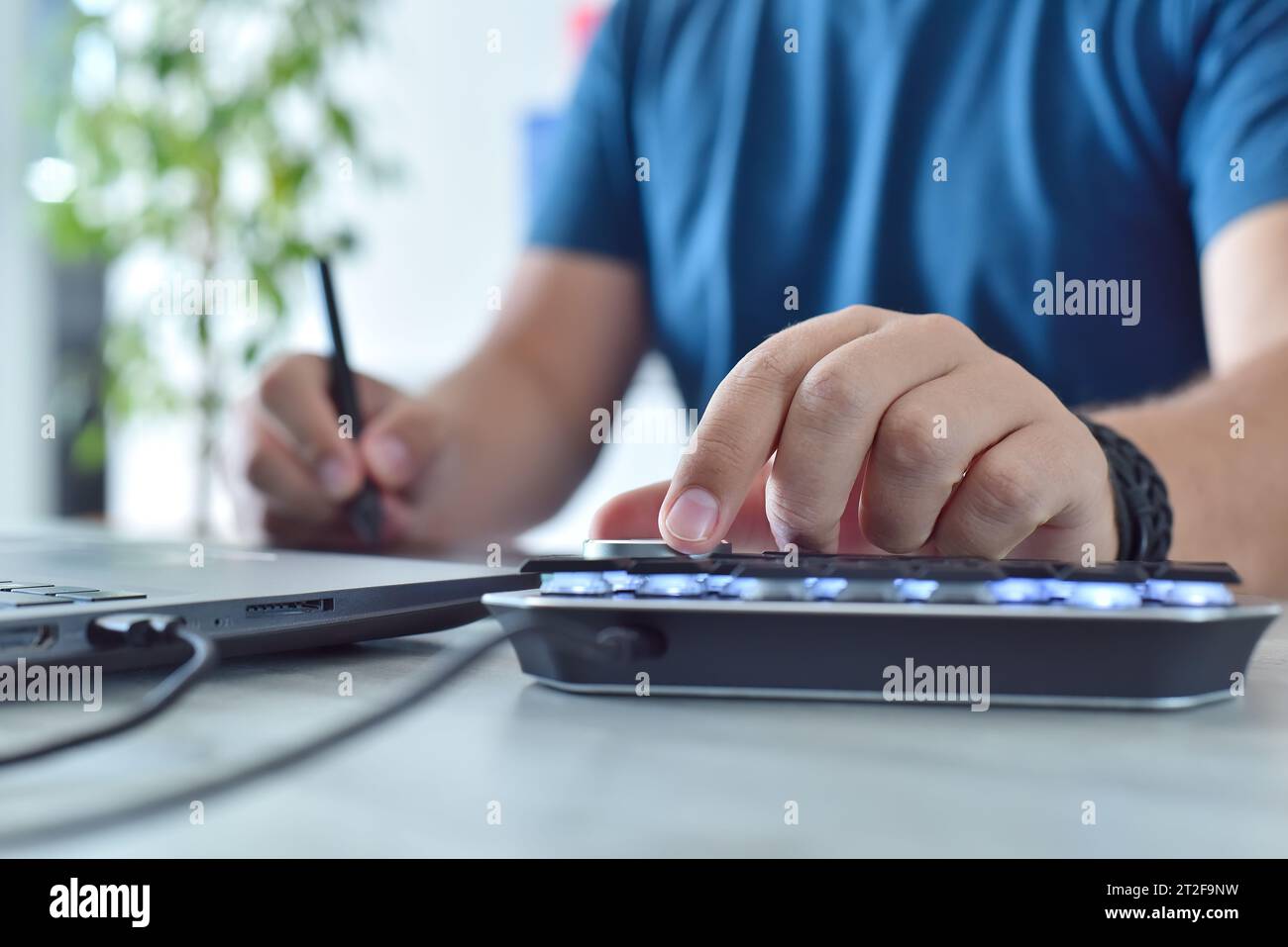 Graphic designer working in office with digital control wheel keyboard ...
