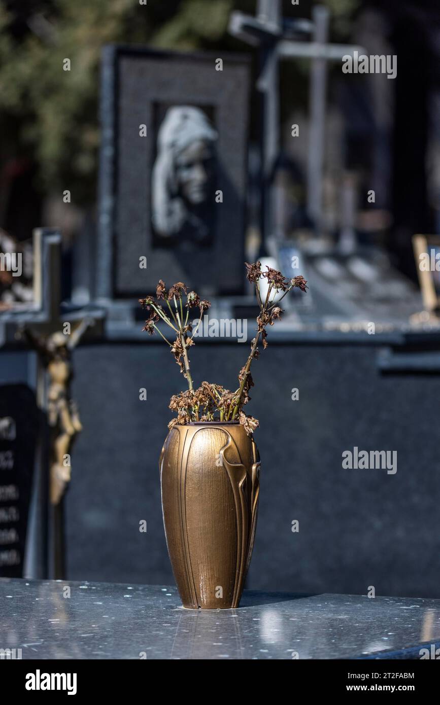 Vase with withered flowers on a grave in a cemetery, Bari Sardo, Sardinia, Italy Stock Photo
