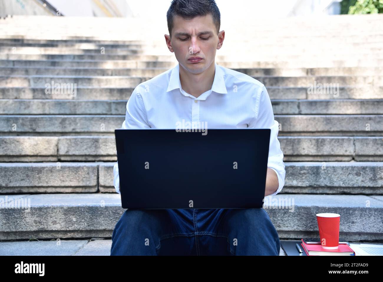 Businessman working outdoor on laptop computer. Business and education concept. Close up Stock Photo