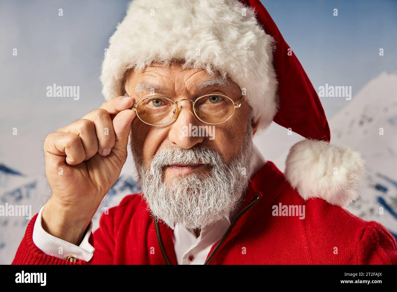 portrait of Santa Claus touching his glasses and looking straight at camera, Merry Christmas Stock Photo