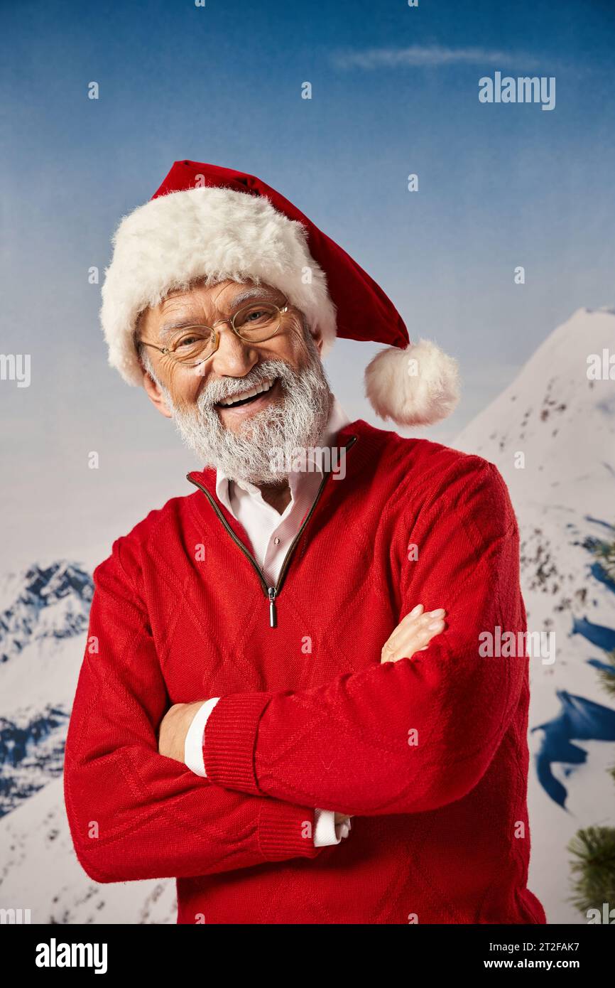 happy white bearded man looking cheerfully at camera with arms crossed on chest, winter concept Stock Photo