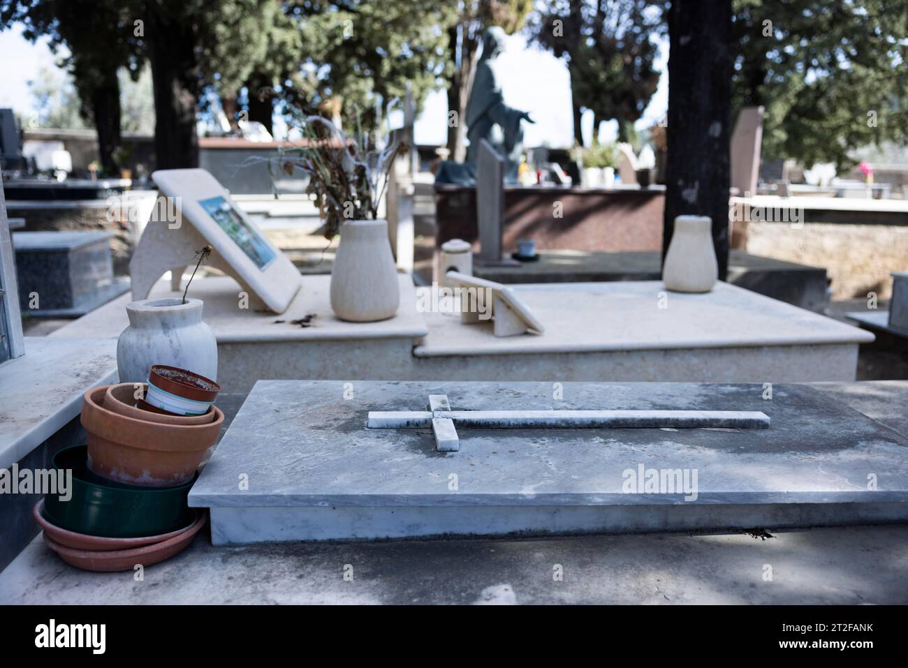 Grave with a single wilted flower in a vase and empty flower pots, Bari Sardo, Sardinia, Italy Stock Photo