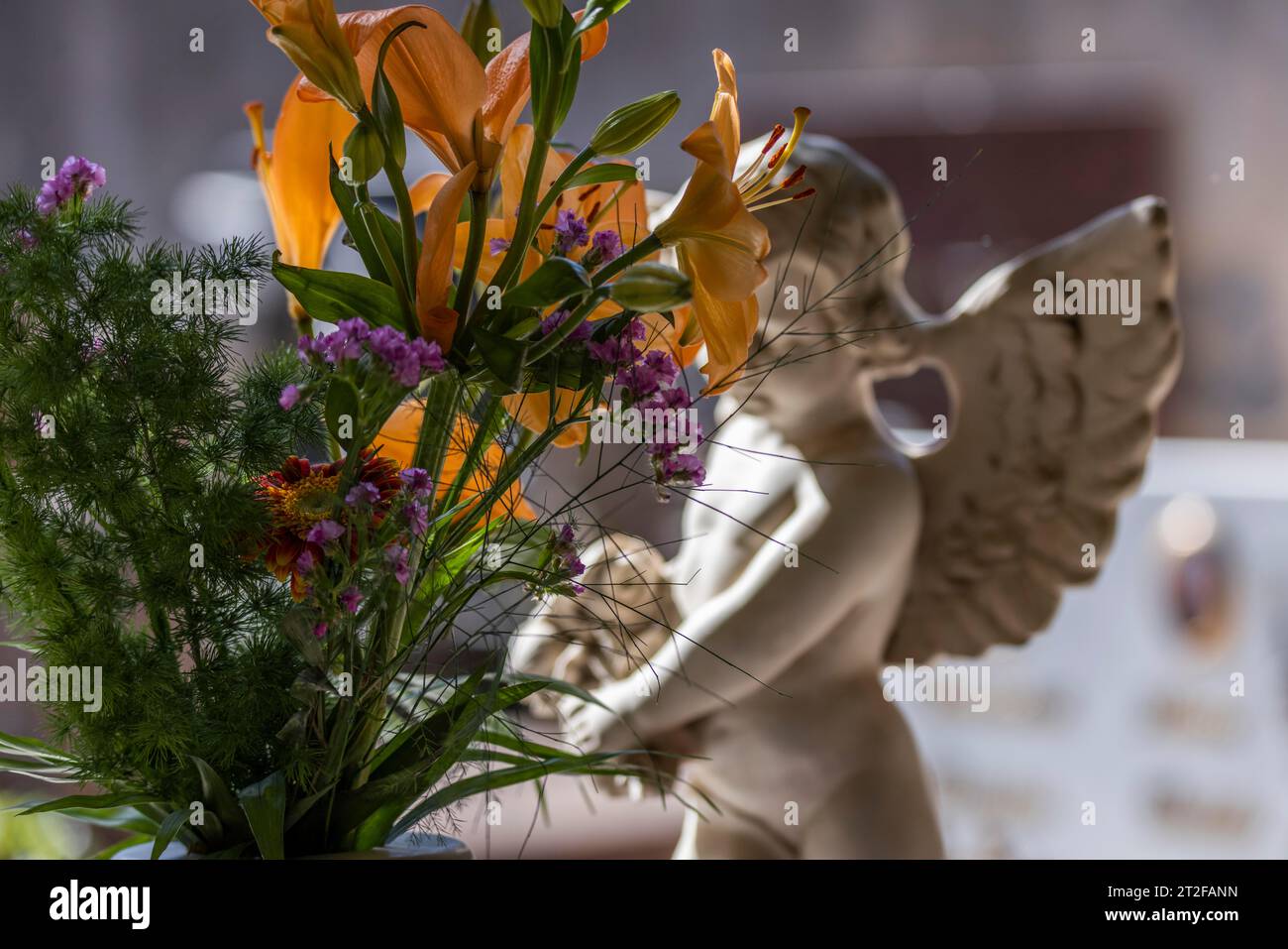 Angel figure, putto and bouquet of flowers on a grave in a cemetery in Sardinia, Bari Sardo, Ogliastra, Sardinia, italy Stock Photo