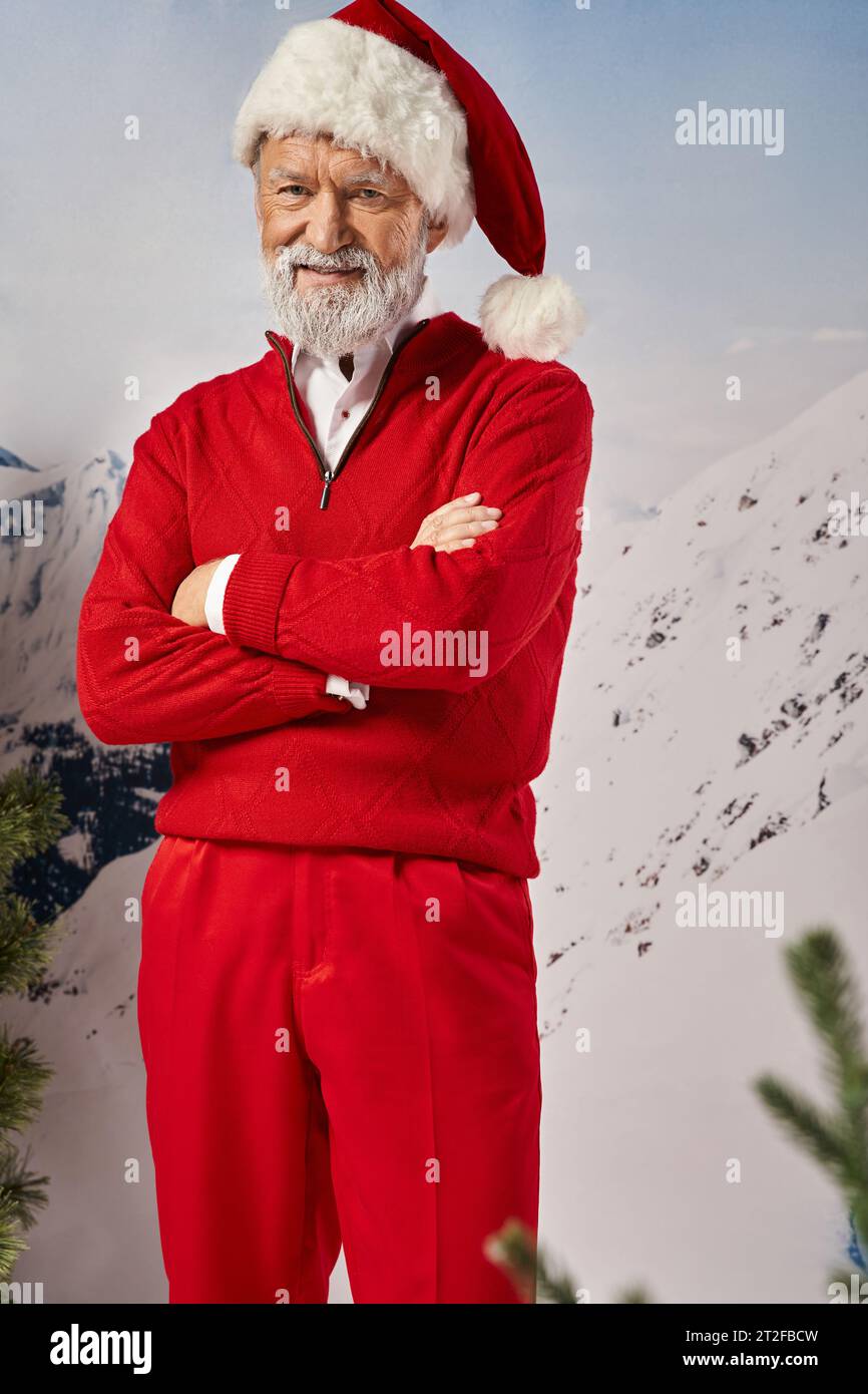 cheerful white bearded man dressed in Santa costume crossing hands smiling at camera, winter concept Stock Photo