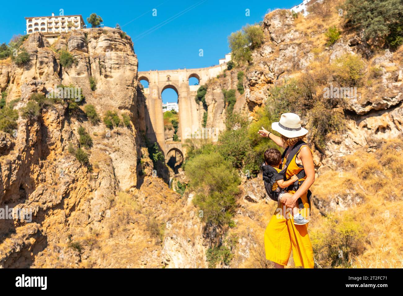 A young mother with her son at the new bridge viewpoint in Ronda Malaga province, Andalucia Stock Photo