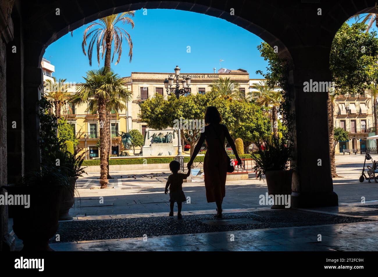 A mother with her son in some arches in Jerez de la Frontera in Cadiz, Andalucia Stock Photo
