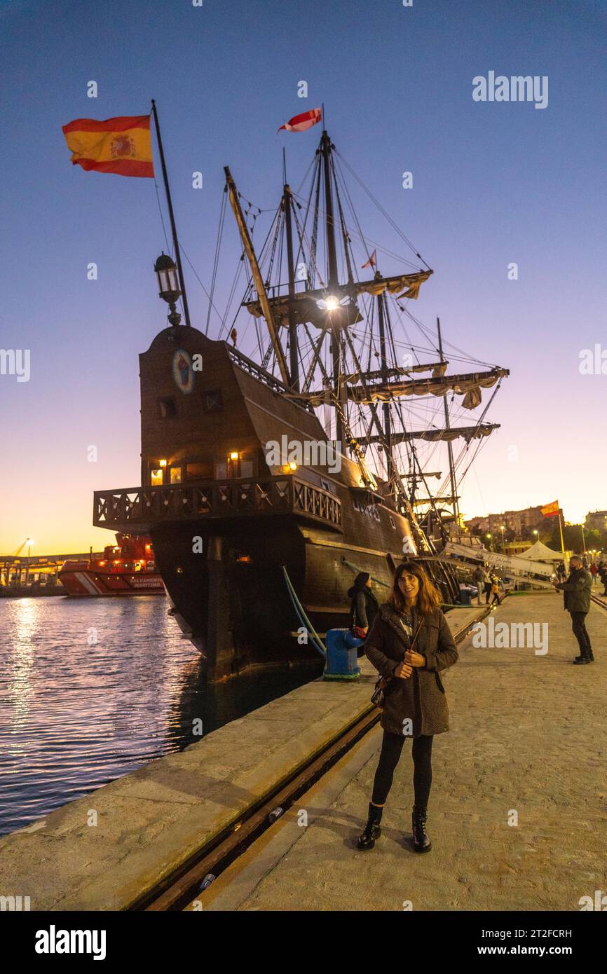 A tourist visiting the old ship at sunset on the promenade of Muelle Uno in the Malagaport of the city of Malaga, Andalusia. Spain Stock Photo