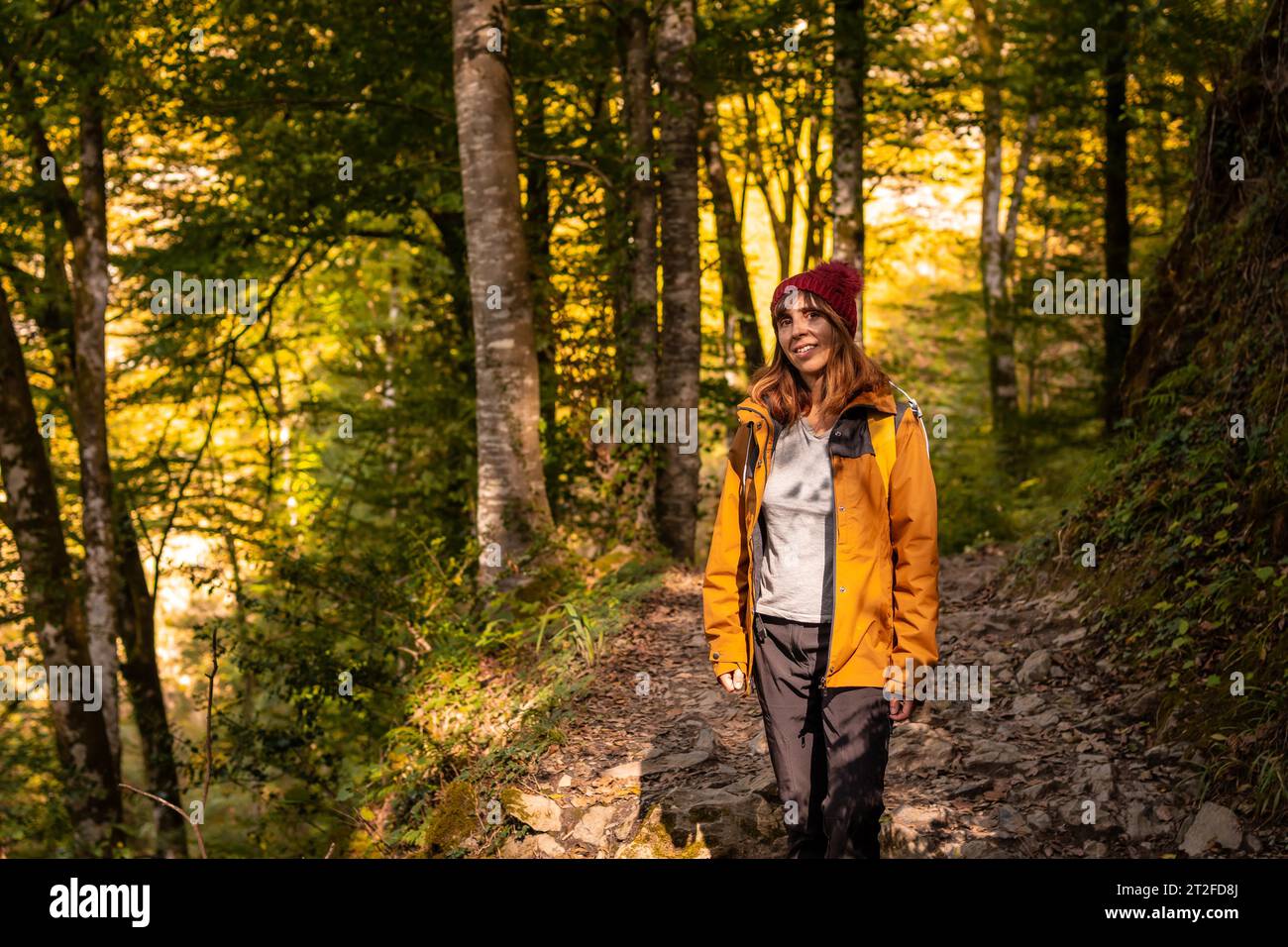 A young hiker on the trail to the Holtzarte suspension bridge, Larrau. In the forest or jungle of Irati, Pyrenees-Atlantiques of France Stock Photo
