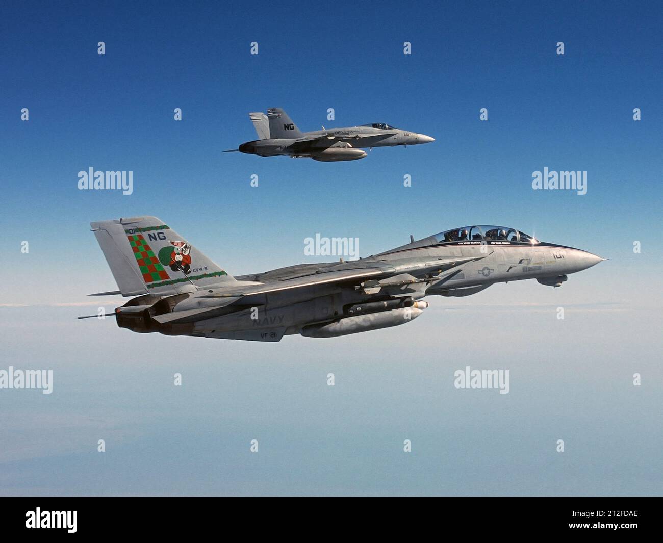 Santa Claus inspired tail design on an F-14, with an F/A-18 wingman flying alongside. Stock Photo