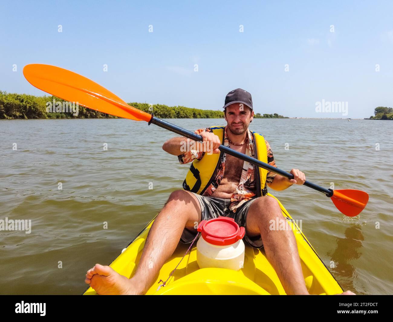 A young man in the canoe doing canoeing in the a natural park of Catalonia, river next to the beach in Estartit Stock Photo