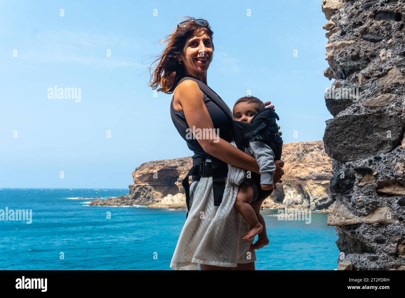 A young mother with her son in the Cuevas de Ajuy, Pajara, west coast of the island of Fuerteventura, Canary Islands. Spain Stock Photo