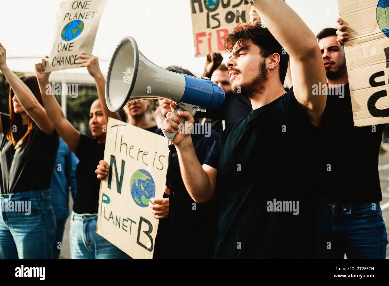 Group of activist on demonstration for climate change holding banners in the city. Global warming environmental concept Stock Photo