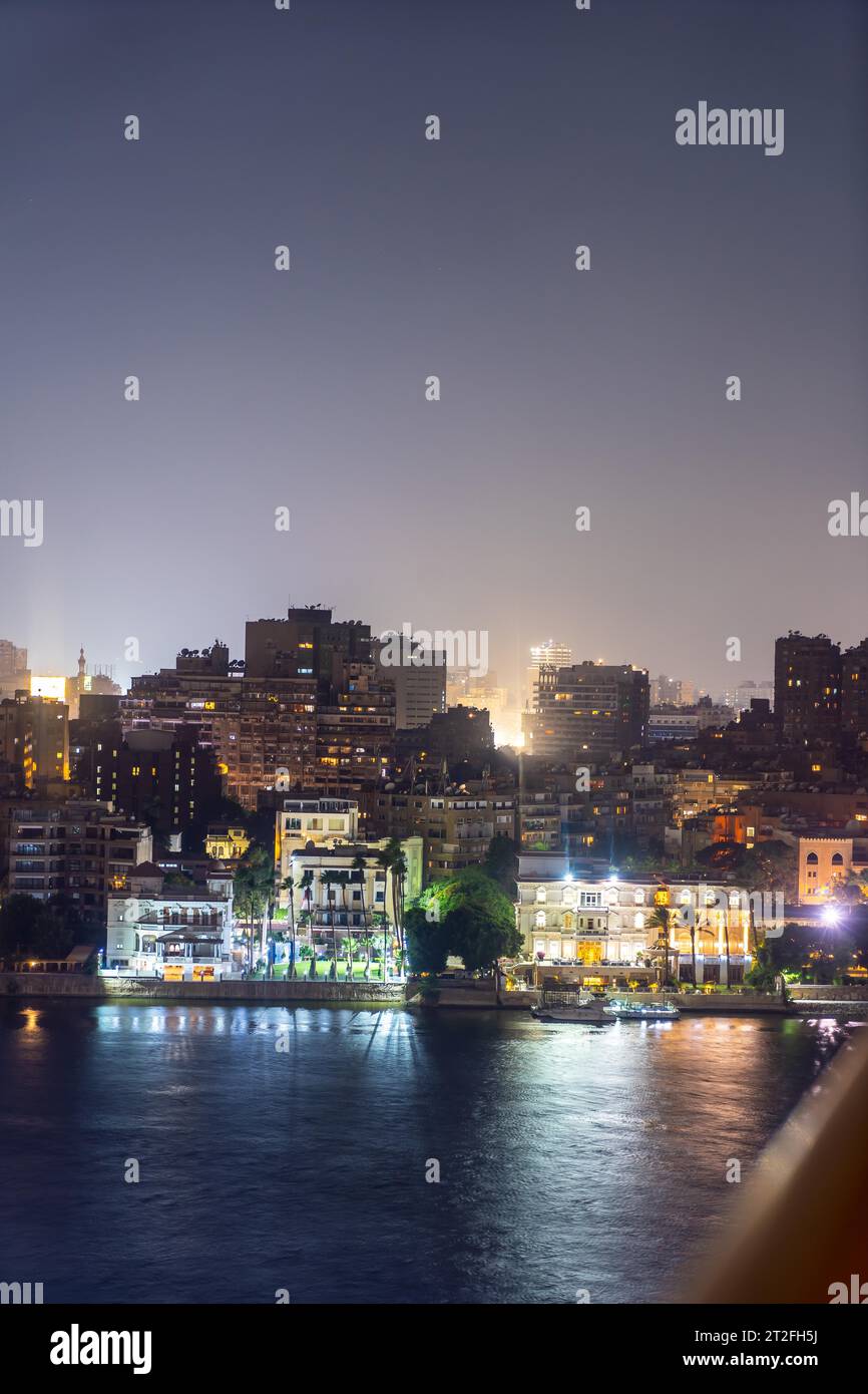 Aerial view of the city of Cairo at night along the river Nile. Skyline ...