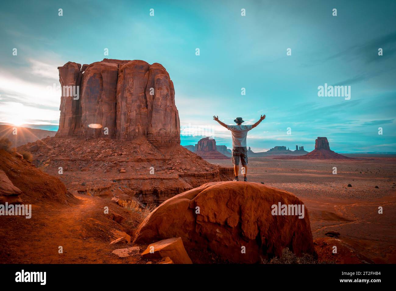 A boy in a white T-shirt in the sunset inside Monument Valley National Park. Utah Stock Photo