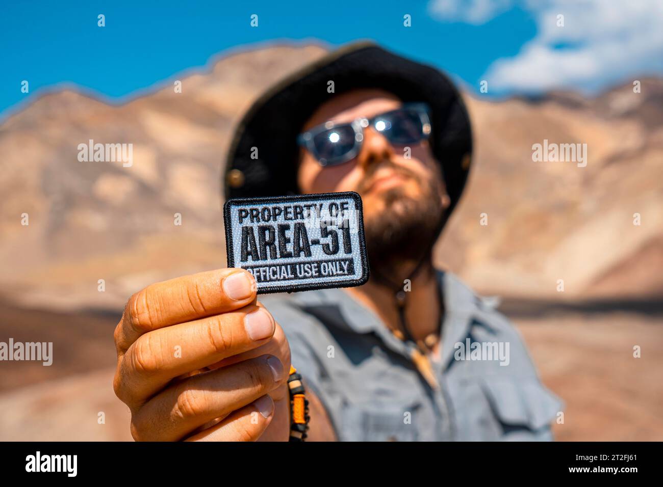 A young man with a patch for Area 51 clothing on Artist's Drive in Death Valley, California. United States Stock Photo