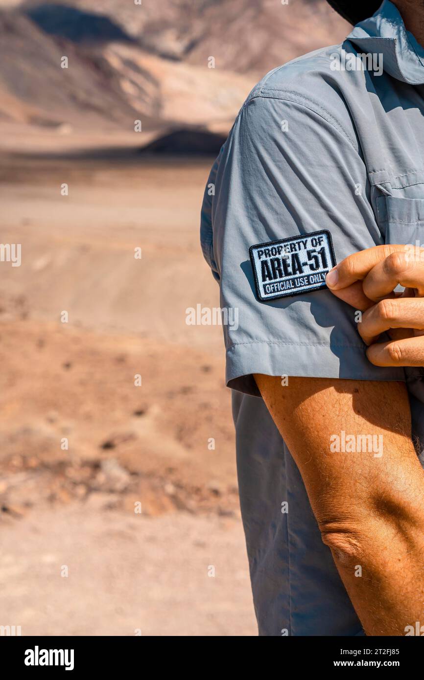 A young man with a patch for Area 51 clothing on Artist's Drive in Death Valley, California. United States Stock Photo