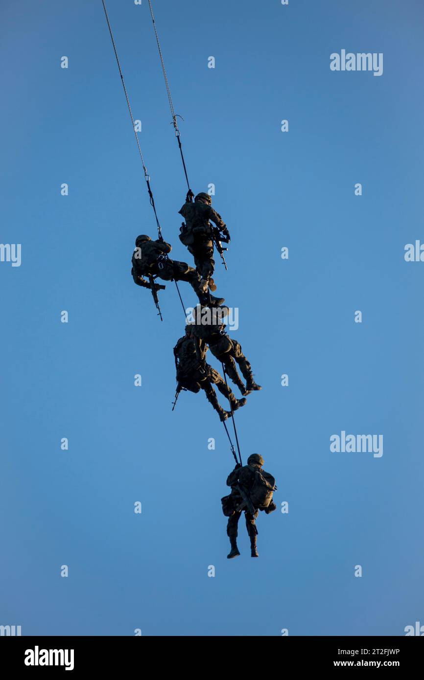 Polish Special Forces attached to a rope hanging from a helicopter. Stock Photo