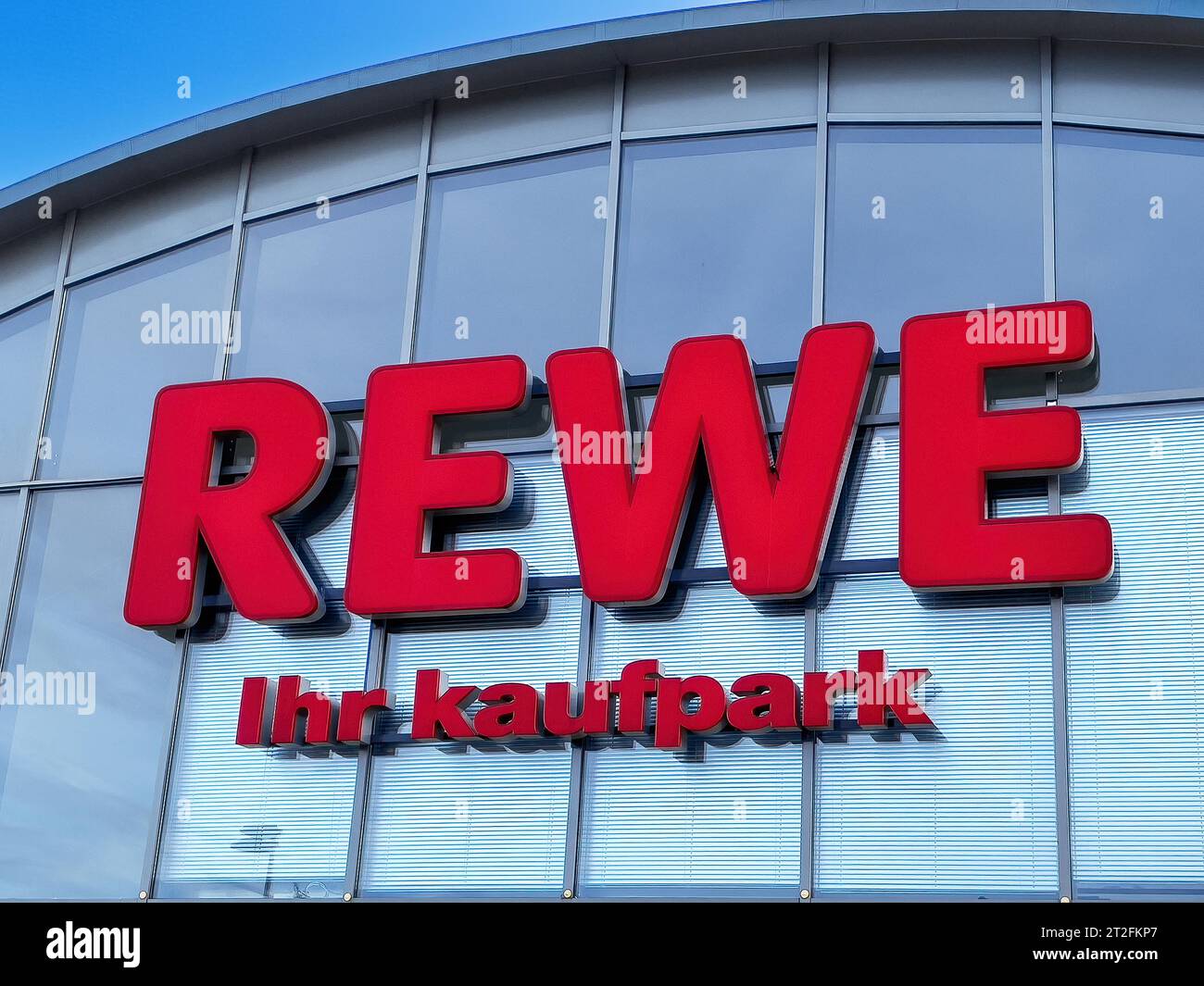 Logo of retail chain retailer grocery chain supermarket chain supermarket Rewe with lettering