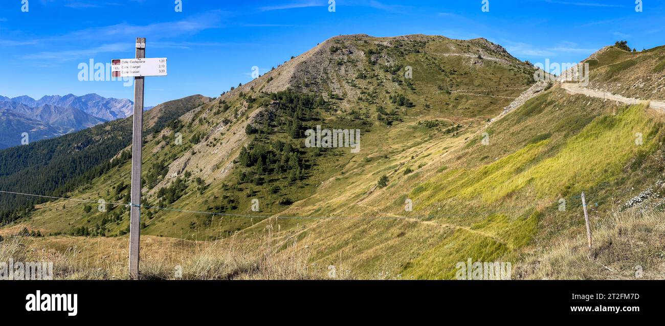 View to Monte Gevris, hiking trail signs to Colle Costapiana, Colle Basset, Colle Bourget, location at Col Blegier, Assietta ridge road, Sestriere Stock Photo