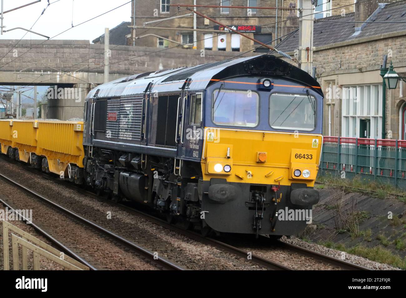 DRS liveried class 66, 66433 named Carlisle Power Signal Box - 50th Anniversary 1973 - 2023, on West Coast Main Line, Carnforth, 18th October 2023. Stock Photo