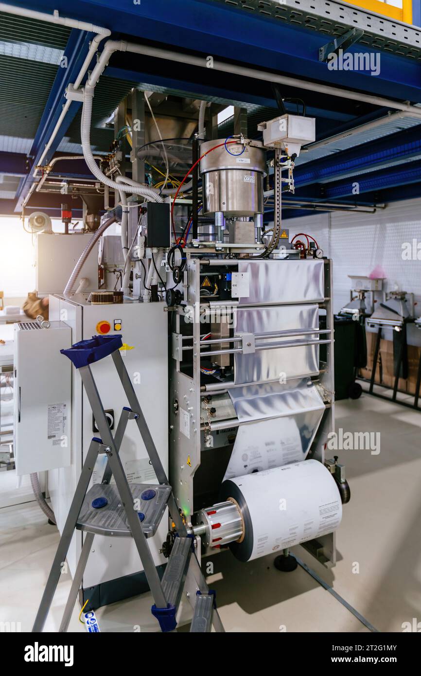 Modern industrial coffee packaging machine. Stock Photo
