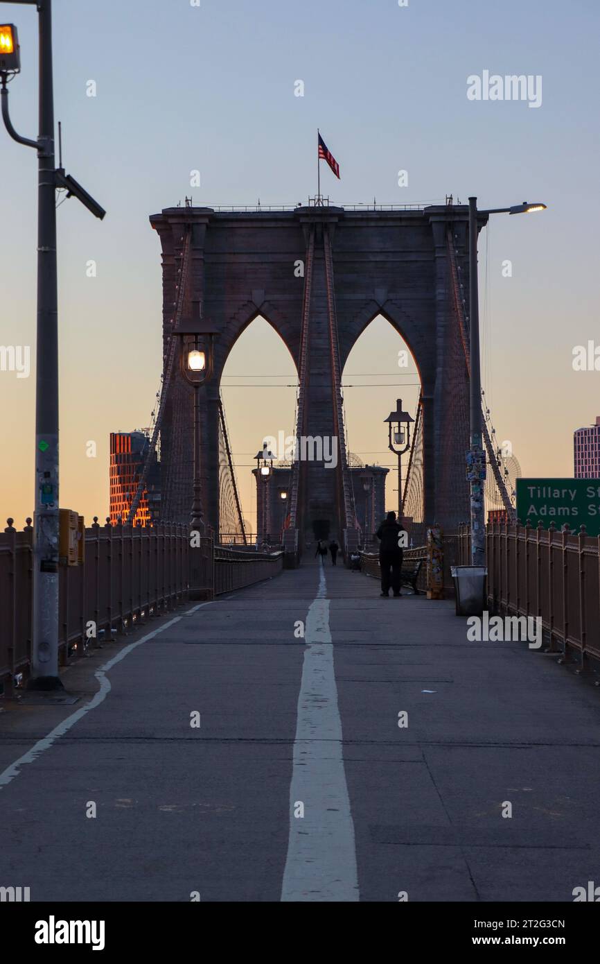 A photo of the Brooklyn Bridge in New York during sunrise with no people. Stock Photo