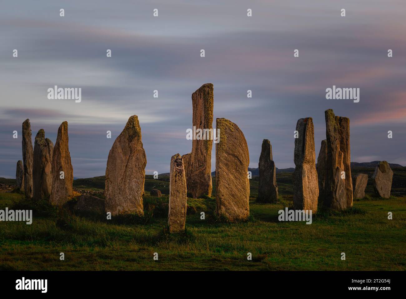 The Callanish Stones are a mysterious and awe-inspiring megalithic stone circle on the Isle of Lewis in the Outer Hebrides of Scotland. Stock Photo