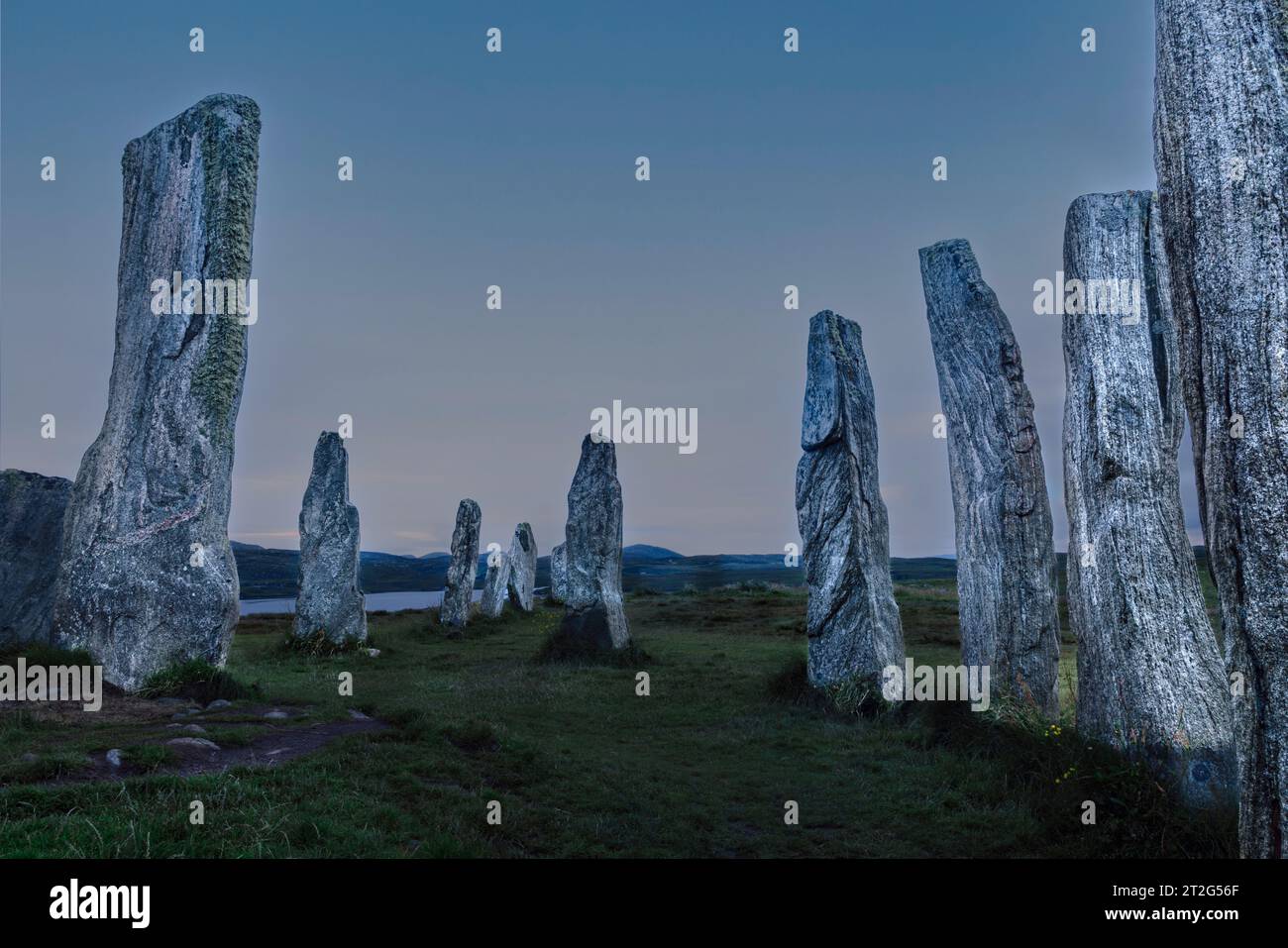 The Callanish Stones are a mysterious and awe-inspiring megalithic stone circle on the Isle of Lewis in the Outer Hebrides of Scotland. Stock Photo
