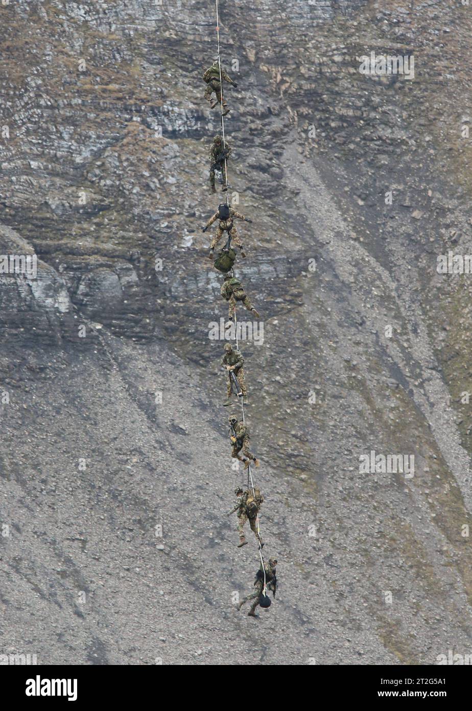 Kommandosoldaten des Schweizer Kommando Spezialkräfte KSK werden auf der Axalp nach ihrem Einsatz von einem Helikopter AS-332 Super Puma an einem Seil hängend aufgenommen und zügig verbracht. Flugvorführungen der Schweizer Luftwaffe auf dem Fliegerschiessplatz Axalp-Ebenfluh am 18. Oktober 2023. Axalp ob Brienz Kanton Bern Schweiz *** Commandos of the Swiss Special Forces Command KSK are picked up by a helicopter AS 332 Super Puma hanging on a rope on the Axalp after their mission and quickly taken away. Flight demonstrations of the Swiss Air Force on the air force firing range Axalp Ebenfluh Stock Photo