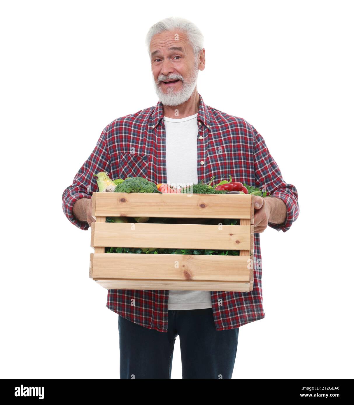 Harvesting season. Happy farmer holding wooden crate with vegetables on ...