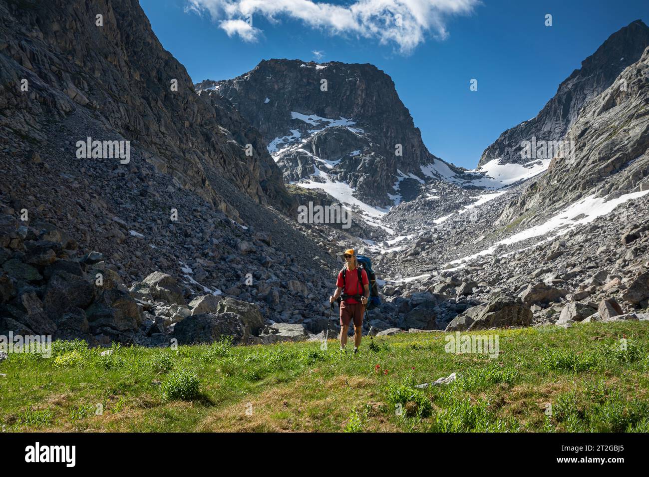 WY05318-00...WYOMING - Hiker in the Wind River Range below rugged Rock Pass; Bridger Wilderness. Stock Photo