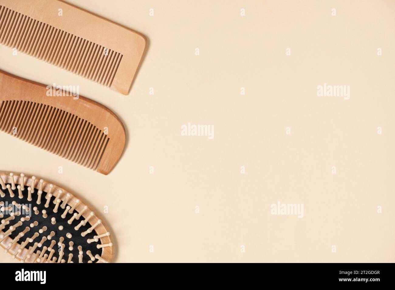 Wooden combs and hair care brush on beige background, top view, space for text. Stock Photo