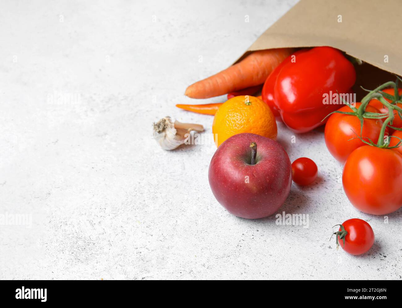 Paper bag with fruits and vegetables on light blue background Stock ...
