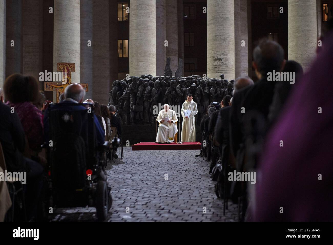 Vatican, Vatican. 19th Oct, 2023. Italy, Rome, Vatican, 2023/10/19 Pope Francis leads a prayer for migrants and refugees, part of the 16th general assembly of the synod of bishops, in front of Timothy Schmalz's bronze sculptural complex 'Angels Unawares' and the San Damiano Cross, left, a large Romanesque rood before which St. Francis of Assisi was praying when he is said to have received the commission from the Lord to rebuild the Church, in St. Peter's Square at The Vatican Photograph by ALESSIA GIULIANI /Catholic Press Photo Credit: Independent Photo Agency/Alamy Live News Stock Photo